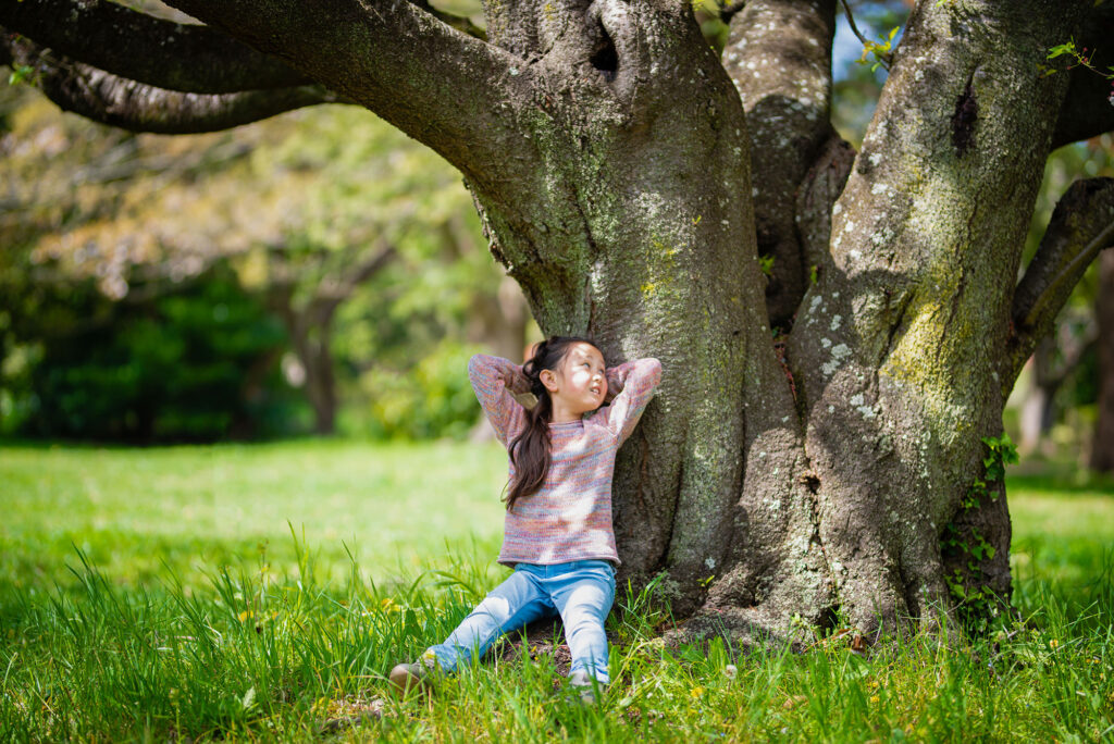 sustainability girl,relaxing,on,a,tree,trunk